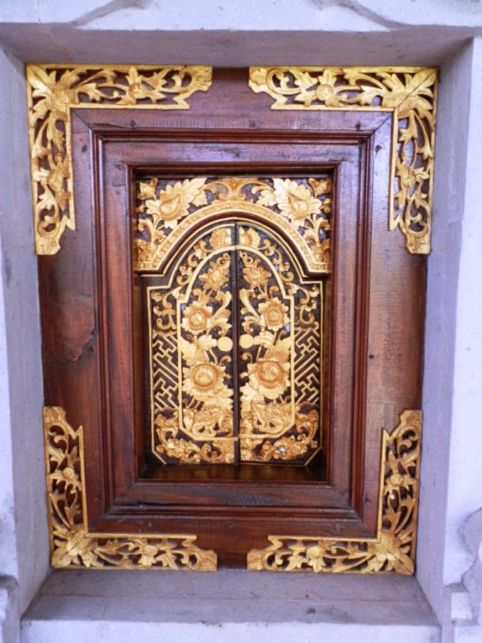 Carved golden ornate window Bali